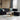 light candle on round white coffee table and sectional sofa
