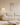 Canapé d’angle modulable en tissu bouclette blanc, style contemporain, dans un salon lumineux avec baie vitrée et décoration minimaliste